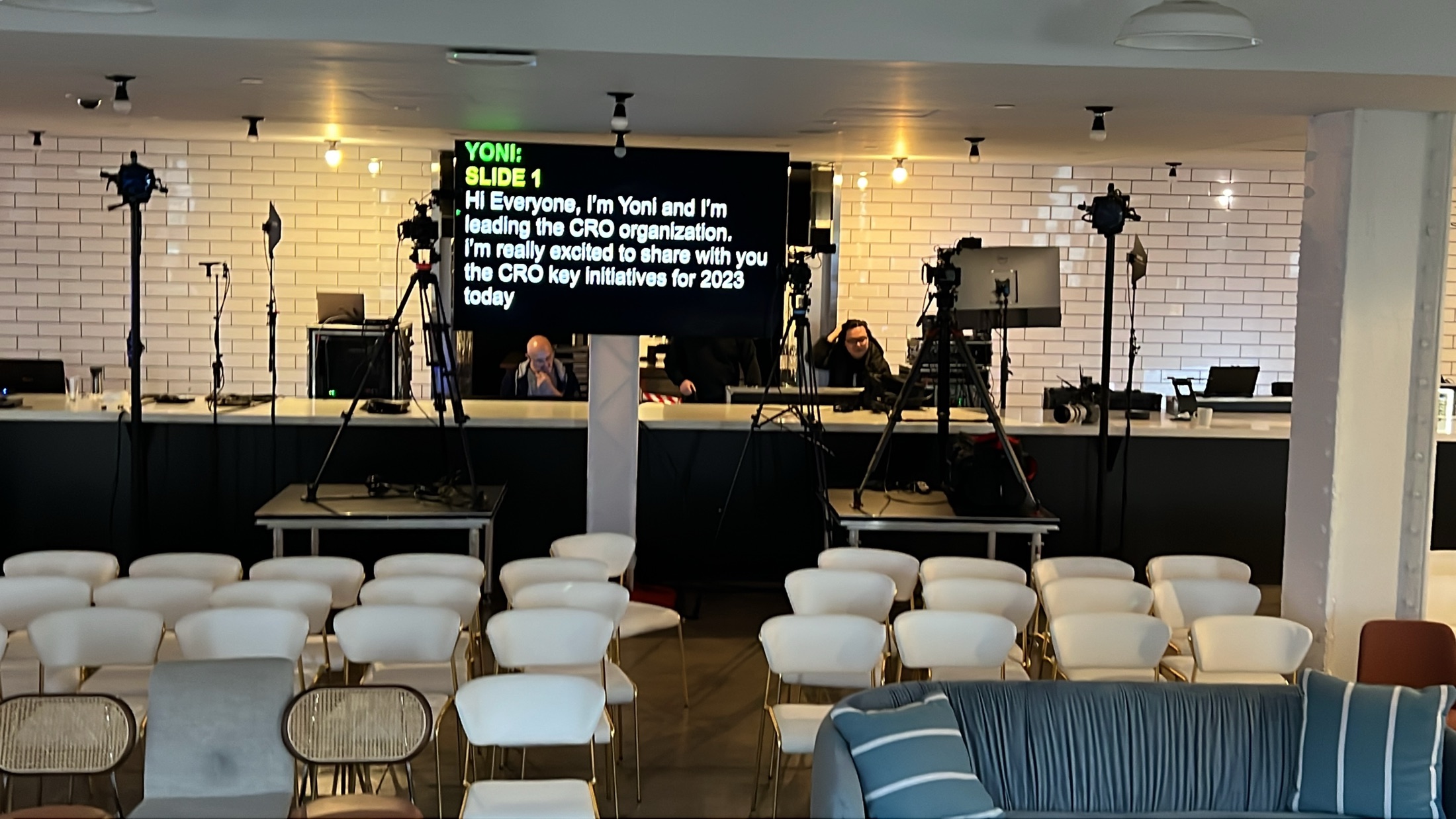 Large teleprompter display positioned behind audience seating in the New York studio