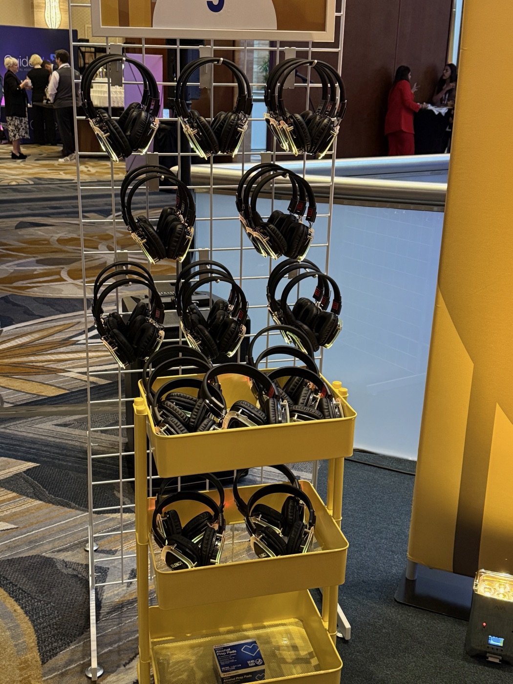 Wireless headphones organized beside a numbered conference station
