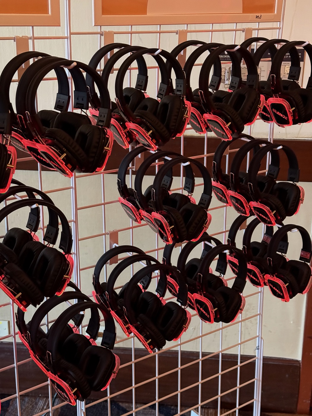 Rows of red illuminated wireless headphones ready for attendees