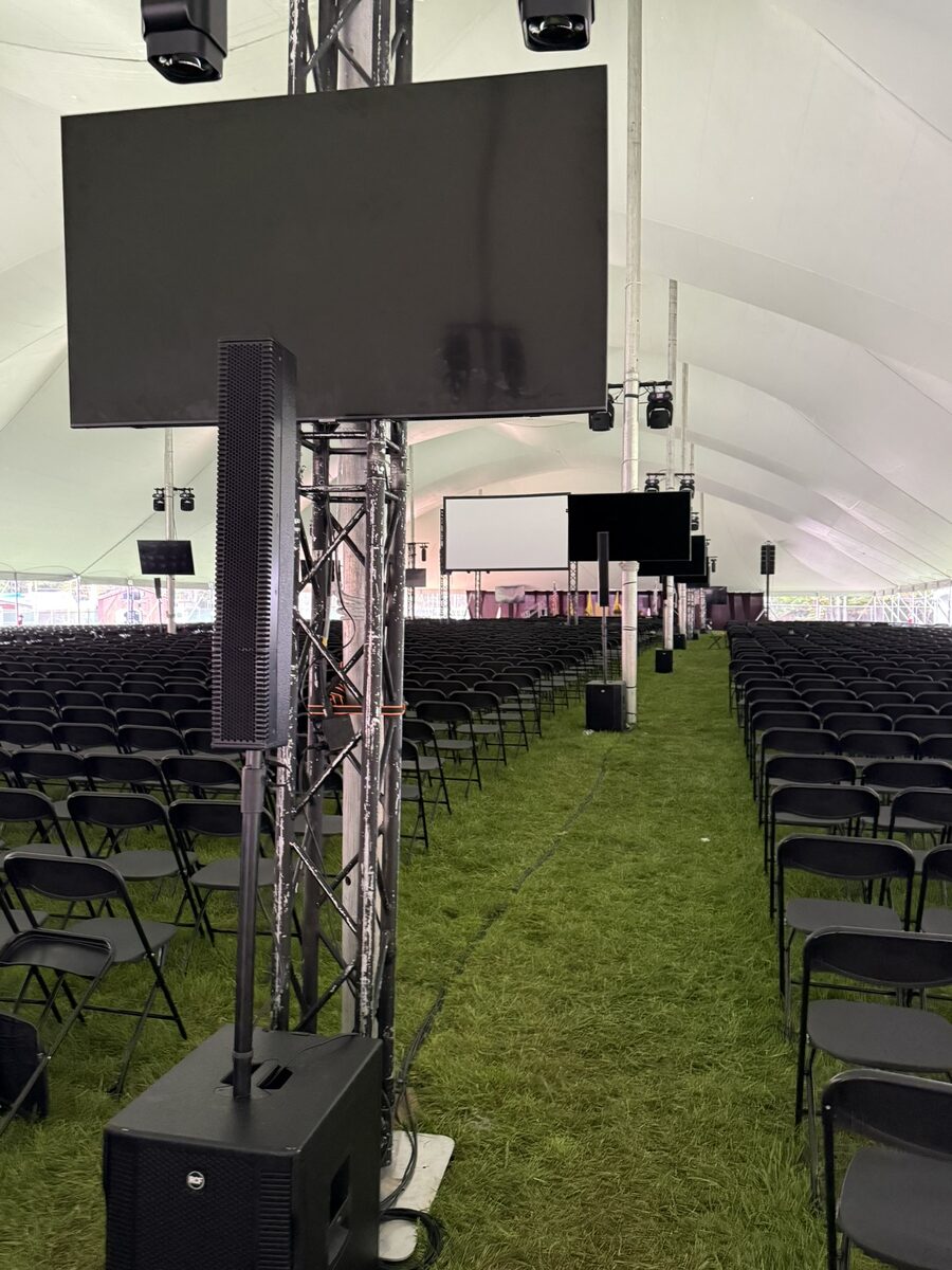 Event setup with screens and truss in tent