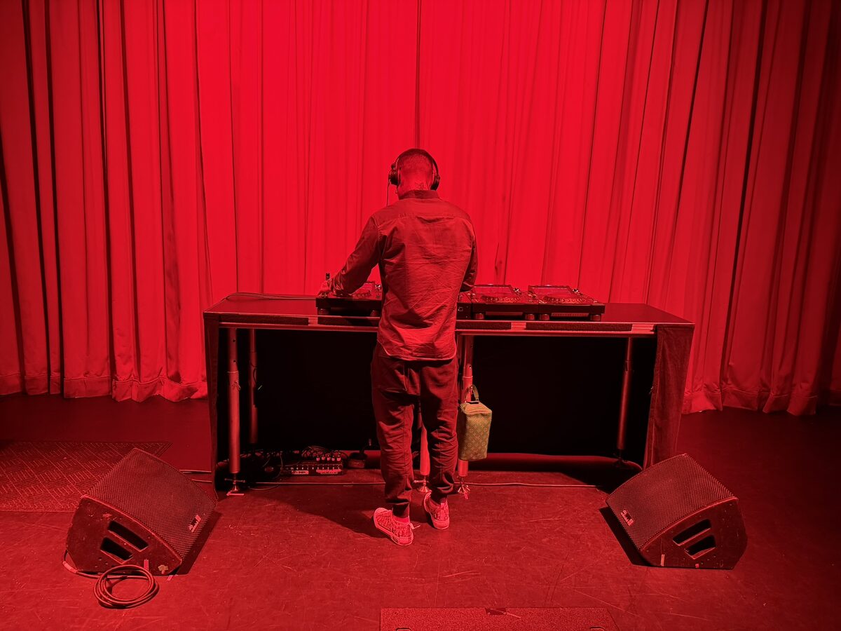 DJ booth with red lighting and monitors