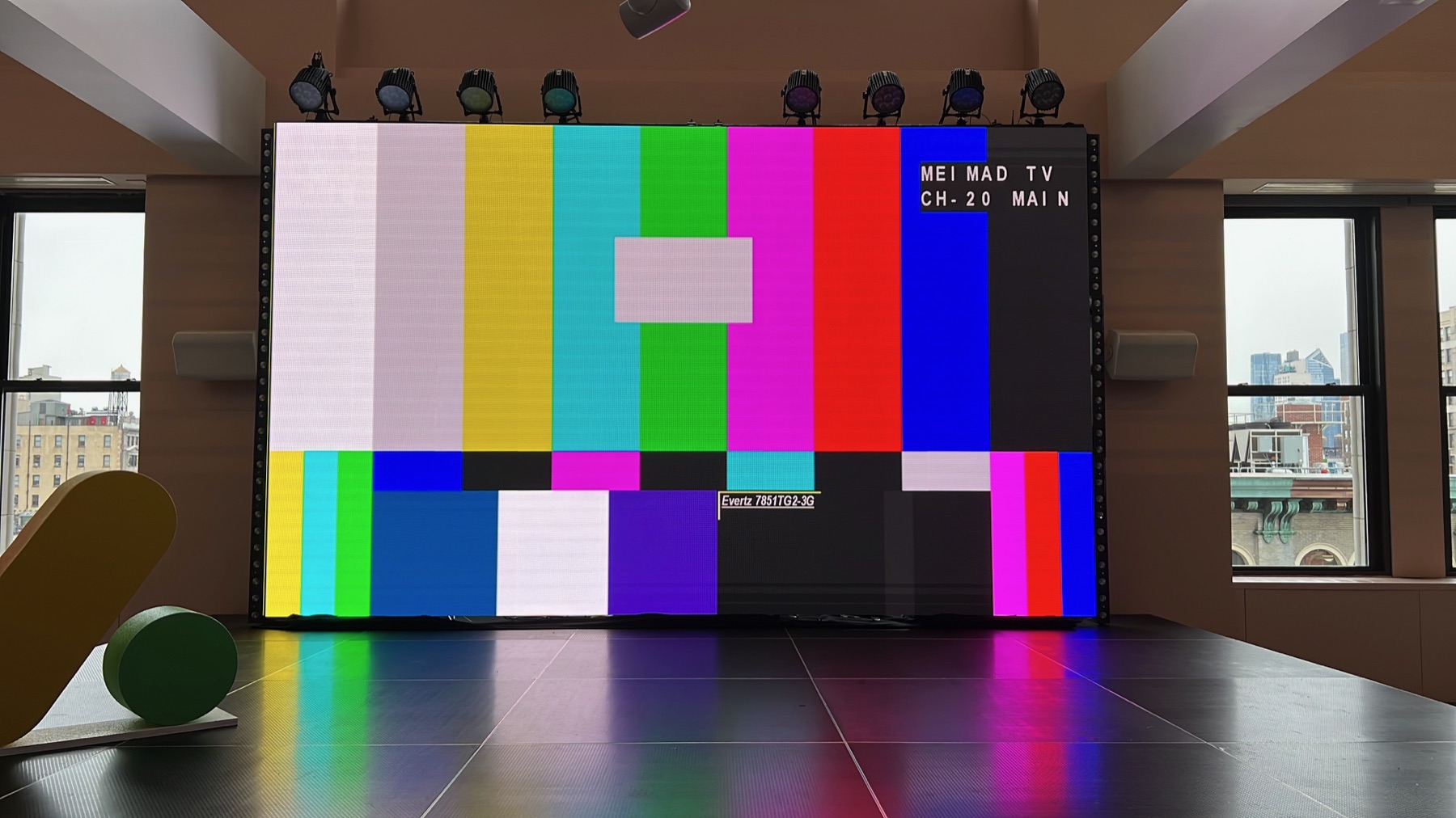 Large LED display installed on a stage inside a Manhattan office