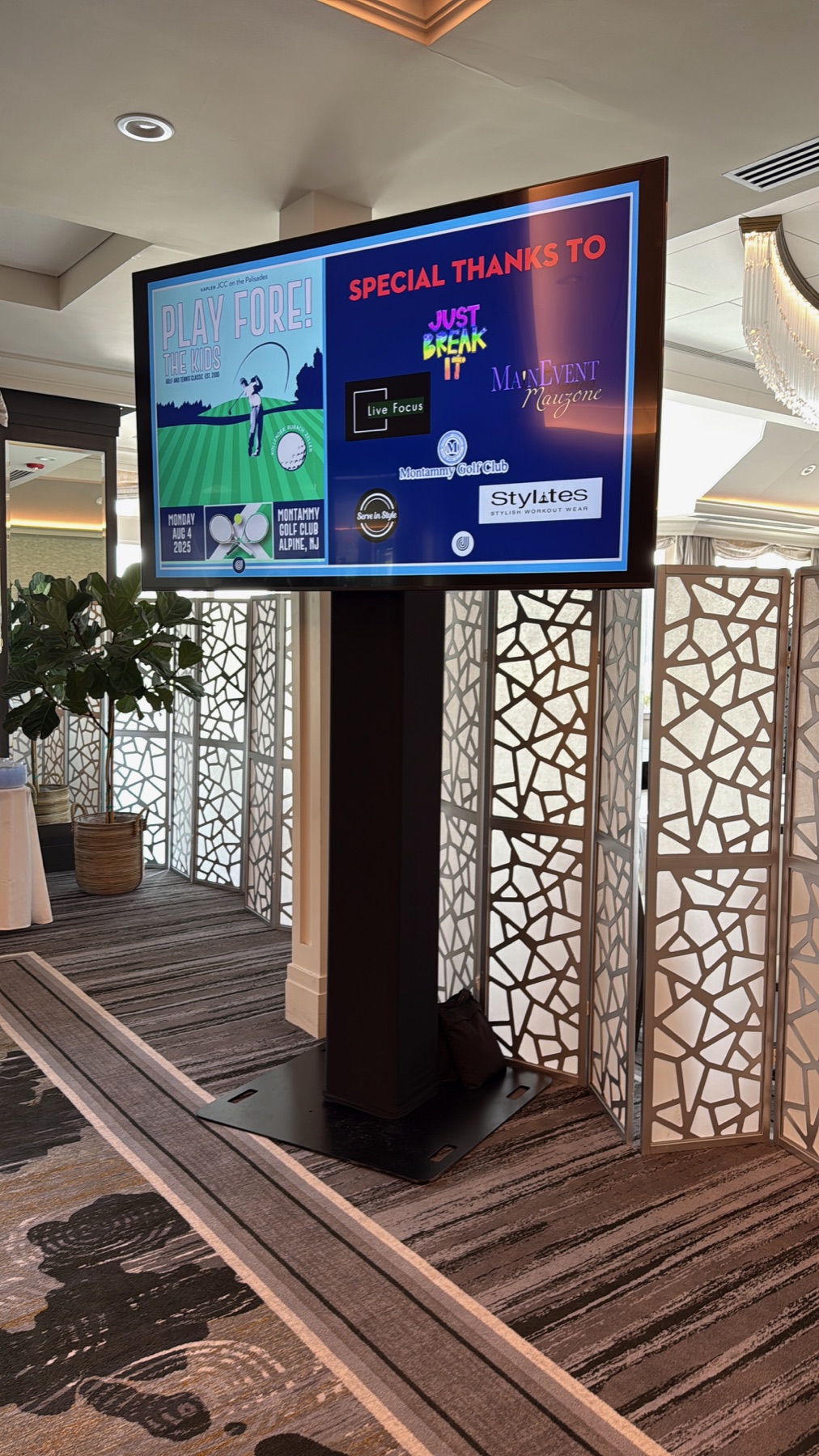 Large TV rental installed on a professional floor stand for an event